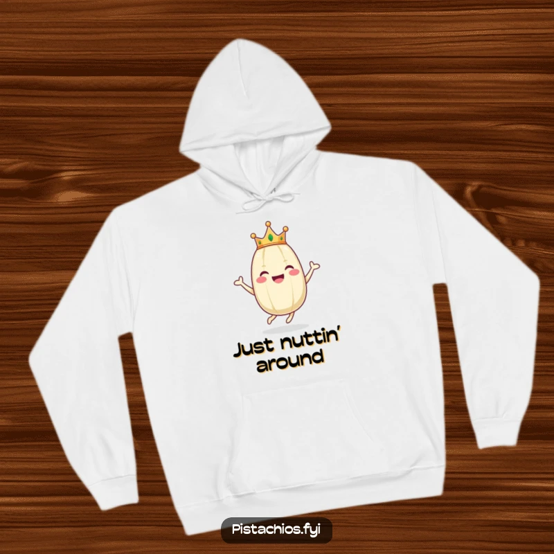 Funny hoodie displays a happy pistachio wearing a mini crown, energetically hopping with pure, unbridled joy and a wide smile.